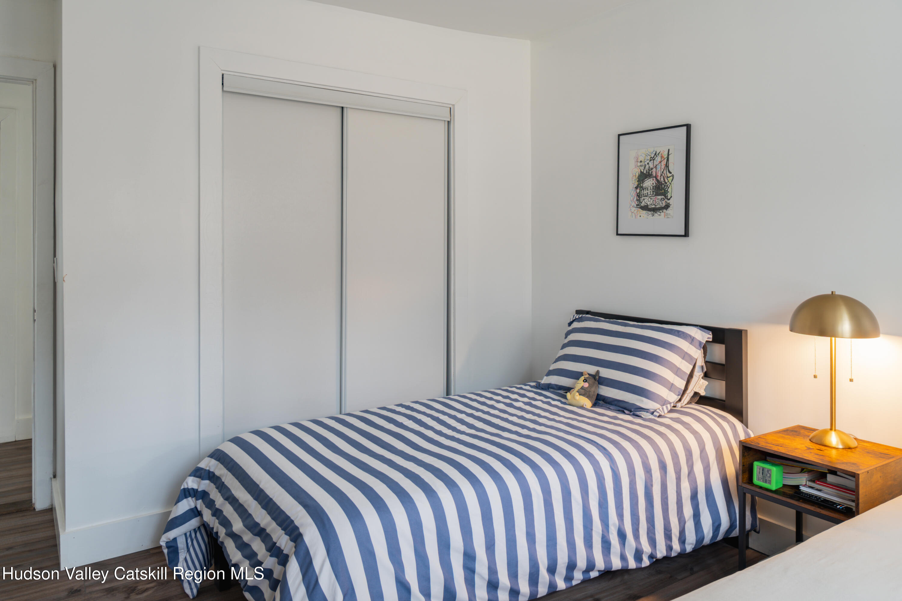 713 Oak Ridge Road Ellenville, NY 12428 - Photo 15 of 53 a bedroom with a bed and painting on the wall