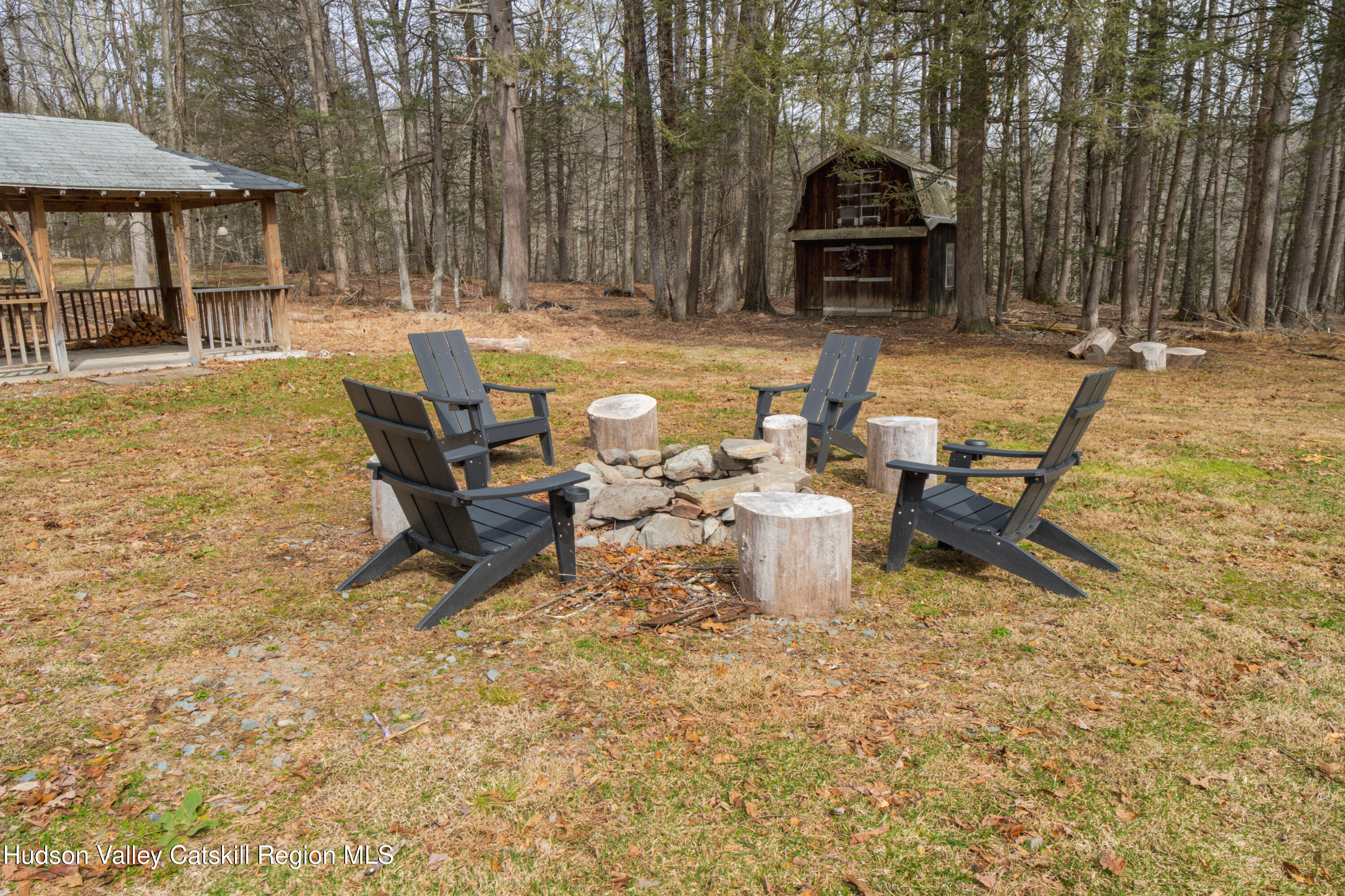 713 Oak Ridge Road Ellenville, NY 12428 - Photo 33 of 53 a view of a backyard with table and chairs under an umbrella