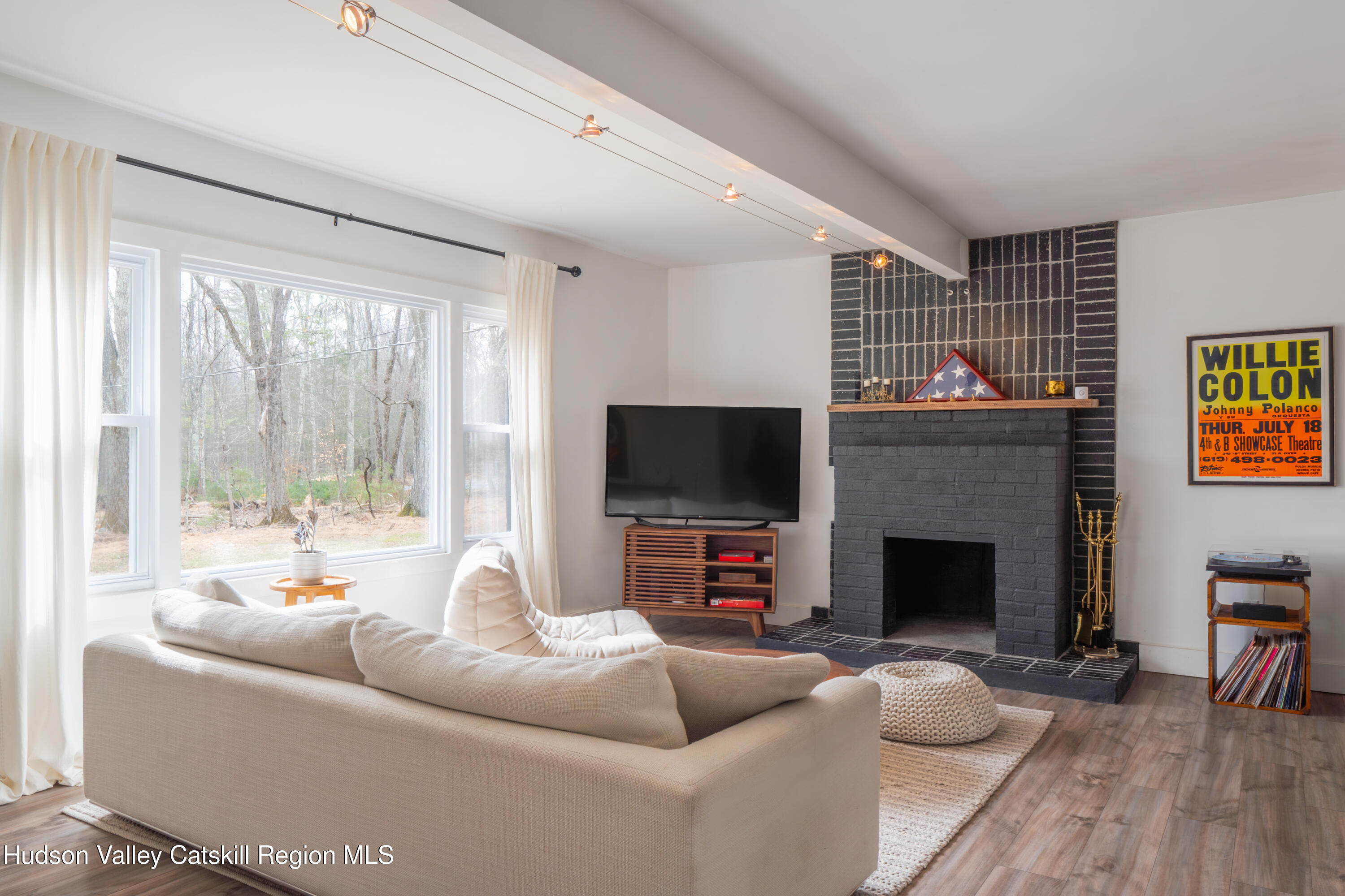 713 Oak Ridge Road Ellenville, NY 12428 - Photo 4 of 53 a living room with furniture a flat screen tv and a fireplace