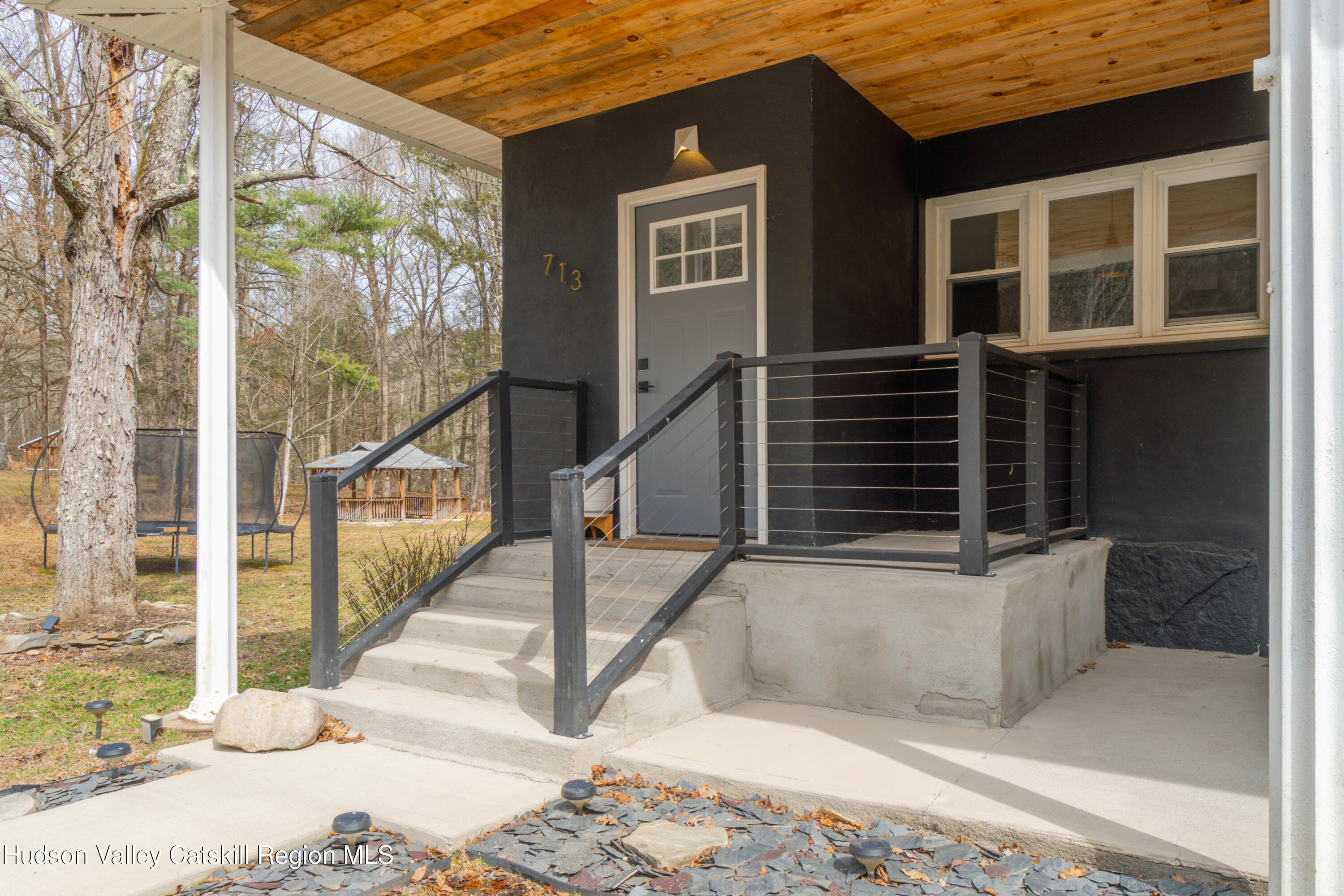 713 Oak Ridge Road Ellenville, NY 12428 - Photo 44 of 53 a view of a brick house with large windows