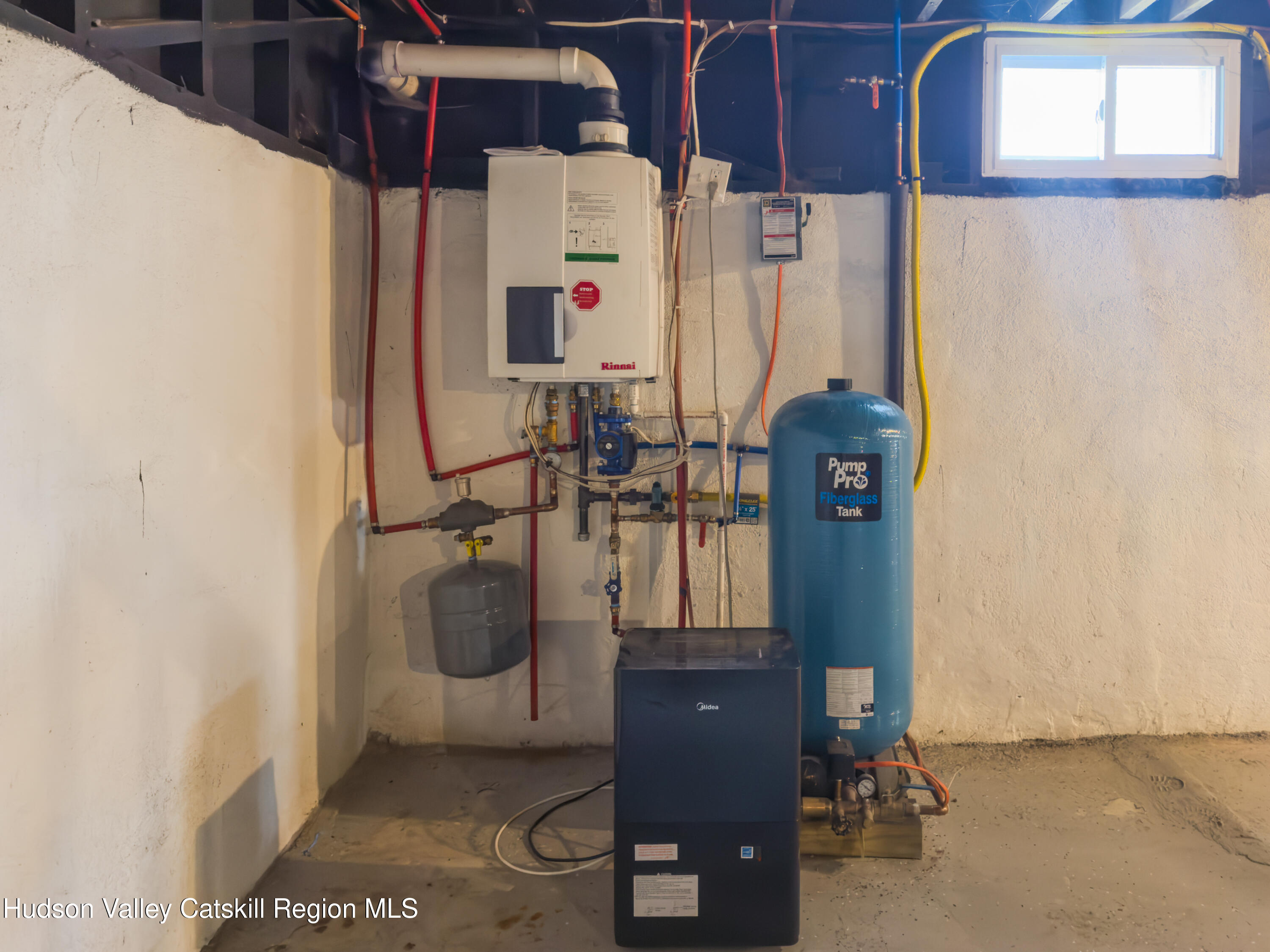 713 Oak Ridge Road Ellenville, NY 12428 - Photo 49 of 53 a room with water heater and white cabinet