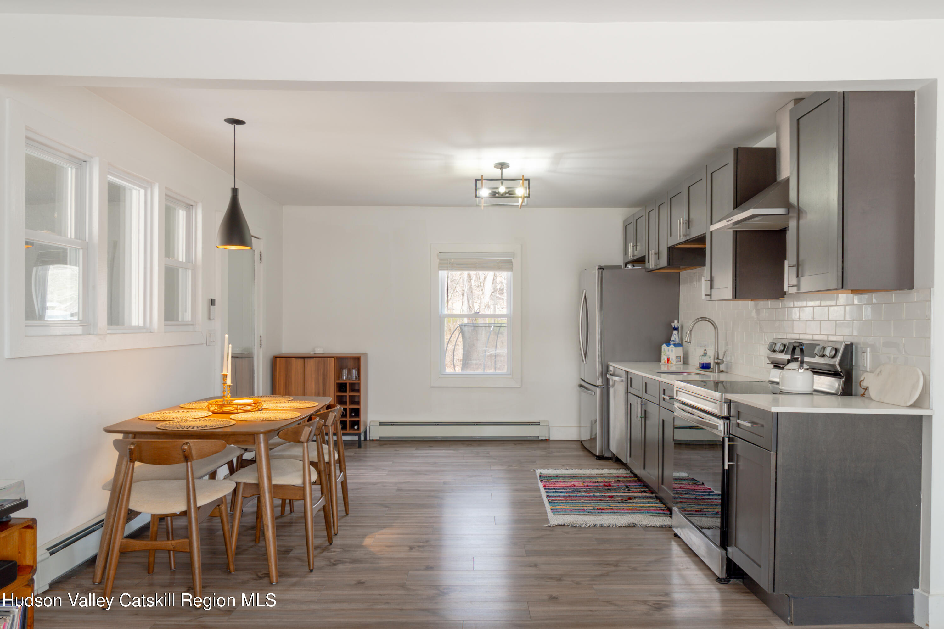 713 Oak Ridge Road Ellenville, NY 12428 - Photo 9 of 53 a kitchen with stainless steel appliances kitchen island granite countertop a table chairs and a refrigerator