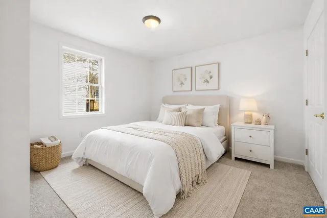 a bedroom with a bed and a night stand