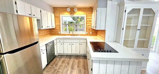 a kitchen with stainless steel appliances granite countertop a refrigerator and a stove