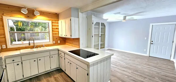 a kitchen with a sink and large window