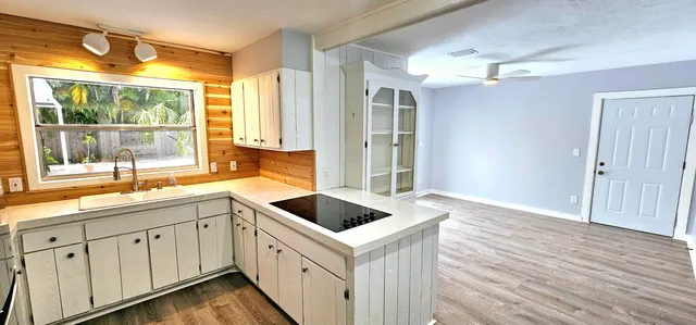 a kitchen with a sink and large window