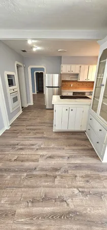 a view of kitchen and wooden floor