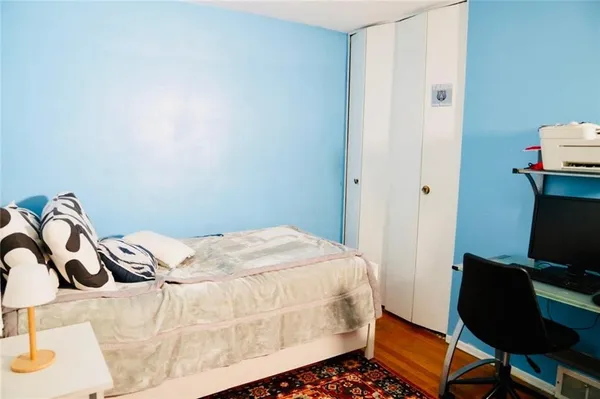 a bedroom with a bed and a chair