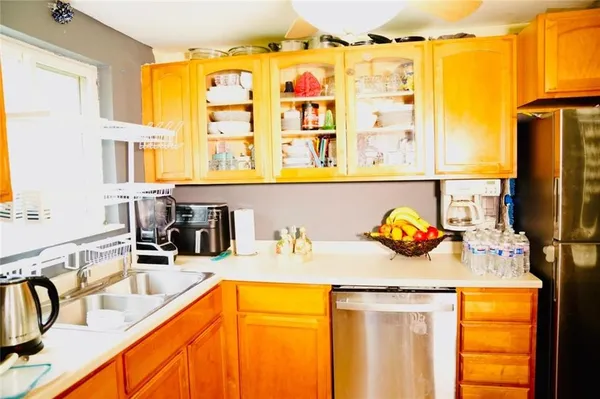 a kitchen with a sink and a refrigerator