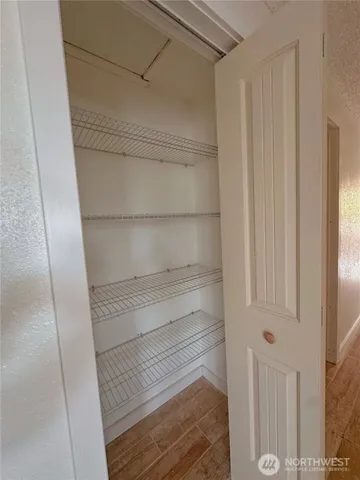 a room with a sink and wooden floor