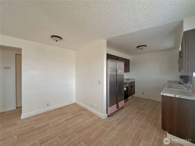 a view of a kitchen empty room and wooden floor
