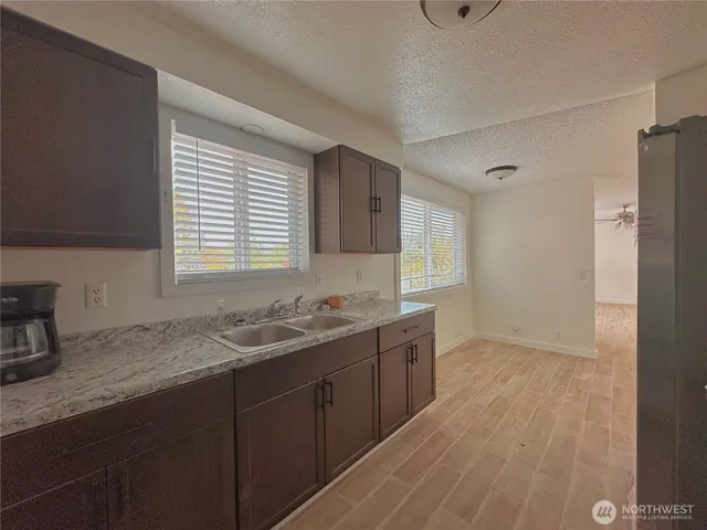 a kitchen with a refrigerator stove and sink
