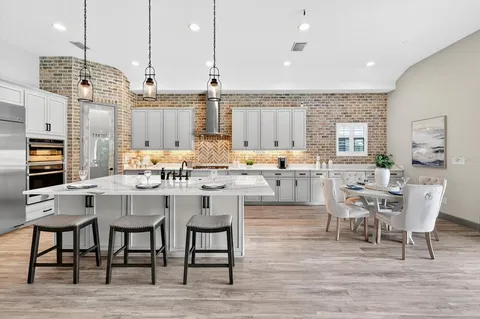 a view of an empty room with wooden floor and window