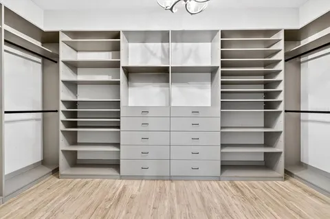 a living room with furniture a floor to ceiling window and a flat screen tv