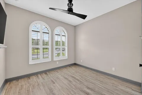 an aerial view of a house with a garden and lake view