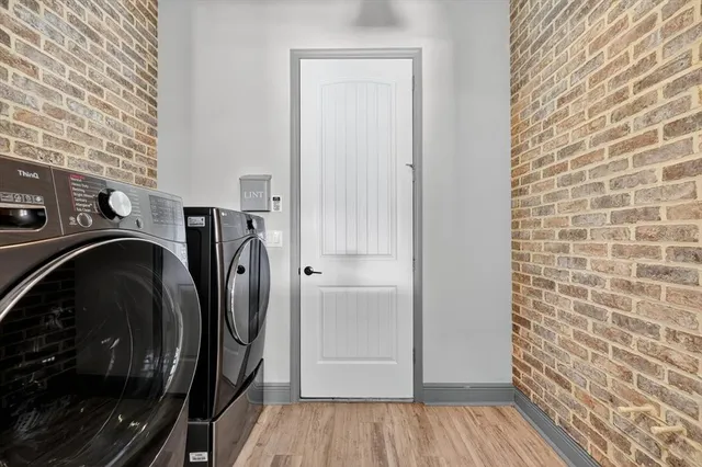 a front view of a house with a yard and potted plants