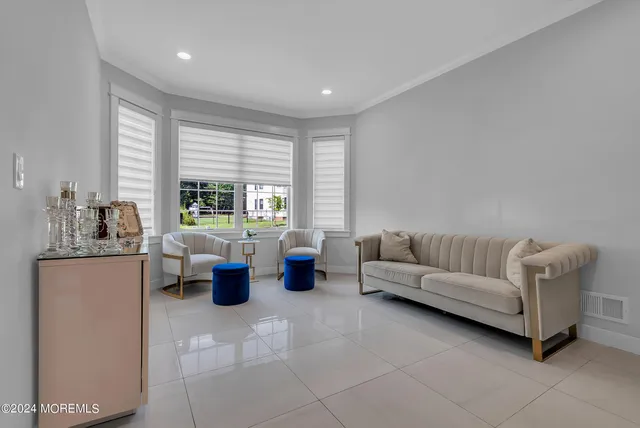 a living room with furniture and large windows