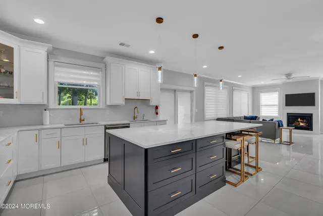 a kitchen with a sink window and cabinets