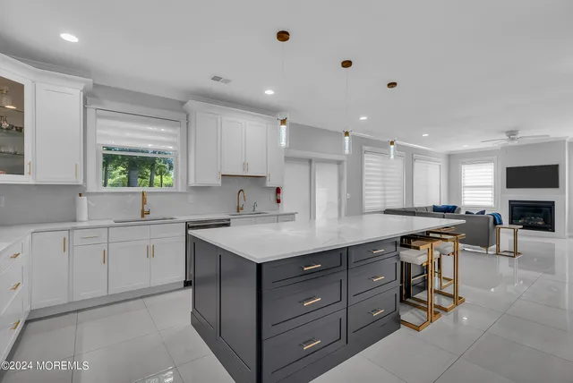 a kitchen with a sink window and cabinets