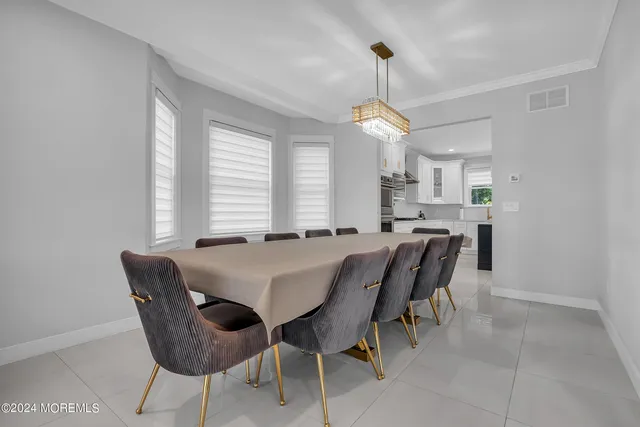 a view of a dining room with furniture and window