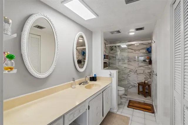 a bathroom with a sink a toilet and a mirror