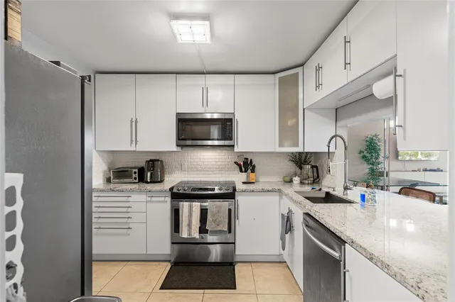 a kitchen with a sink a stove and cabinets