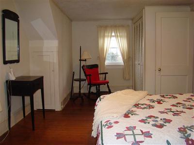 34 Benedict Road Bourne, MA 02532 - Photo 6 of 16 a bedroom with a bed and a chair in it