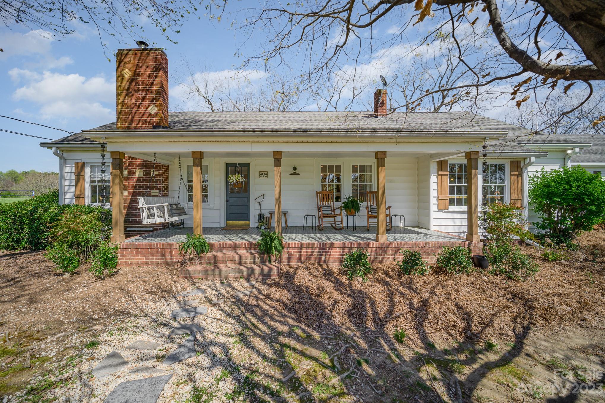 898 Hilltop Road Oakboro, NC 28129 - Photo 14 of 34 a view of a house with a patio