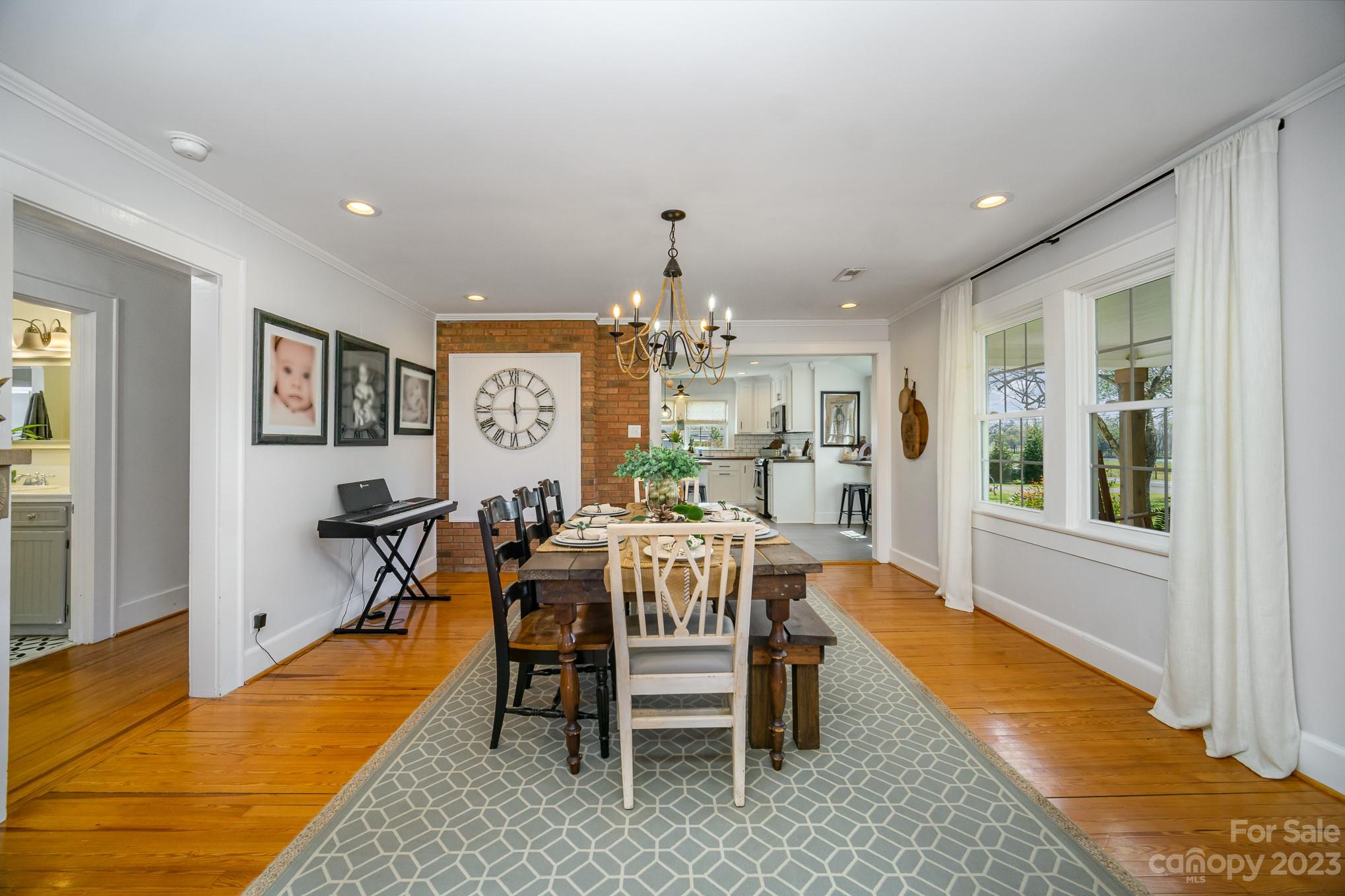 898 Hilltop Road Oakboro, NC 28129 - Photo 18 of 34 a dining room with furniture a rug and a chandelier