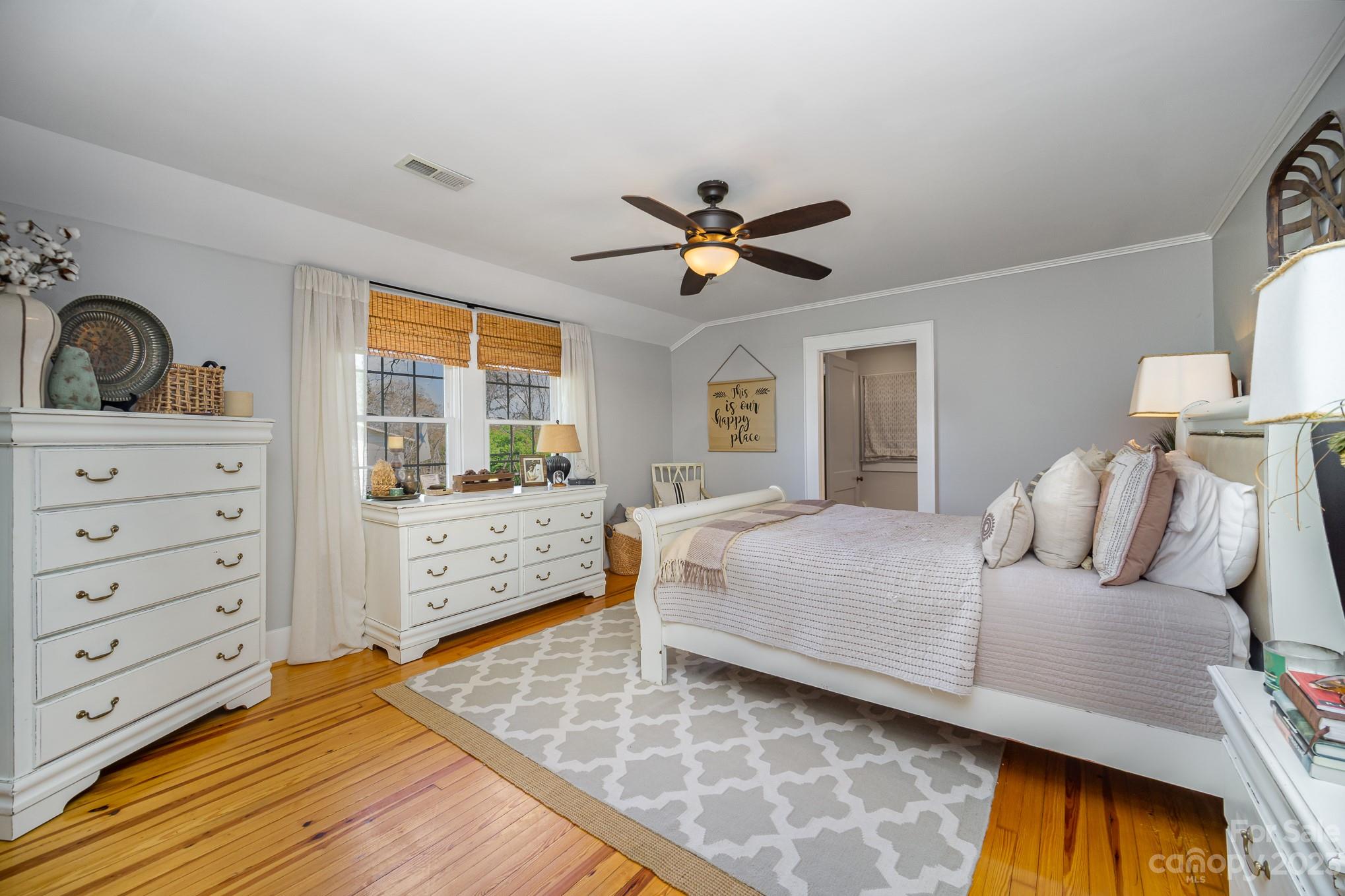 898 Hilltop Road Oakboro, NC 28129 - Photo 25 of 34 a bedroom with a bed and a chandelier