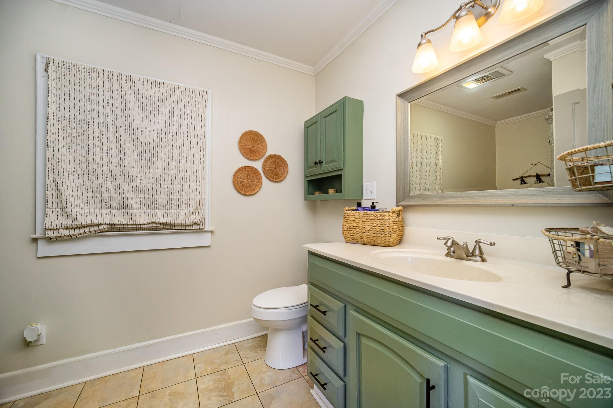 898 Hilltop Road Oakboro, NC 28129 - Photo 27 of 34 a bathroom with a toilet sink and mirror
