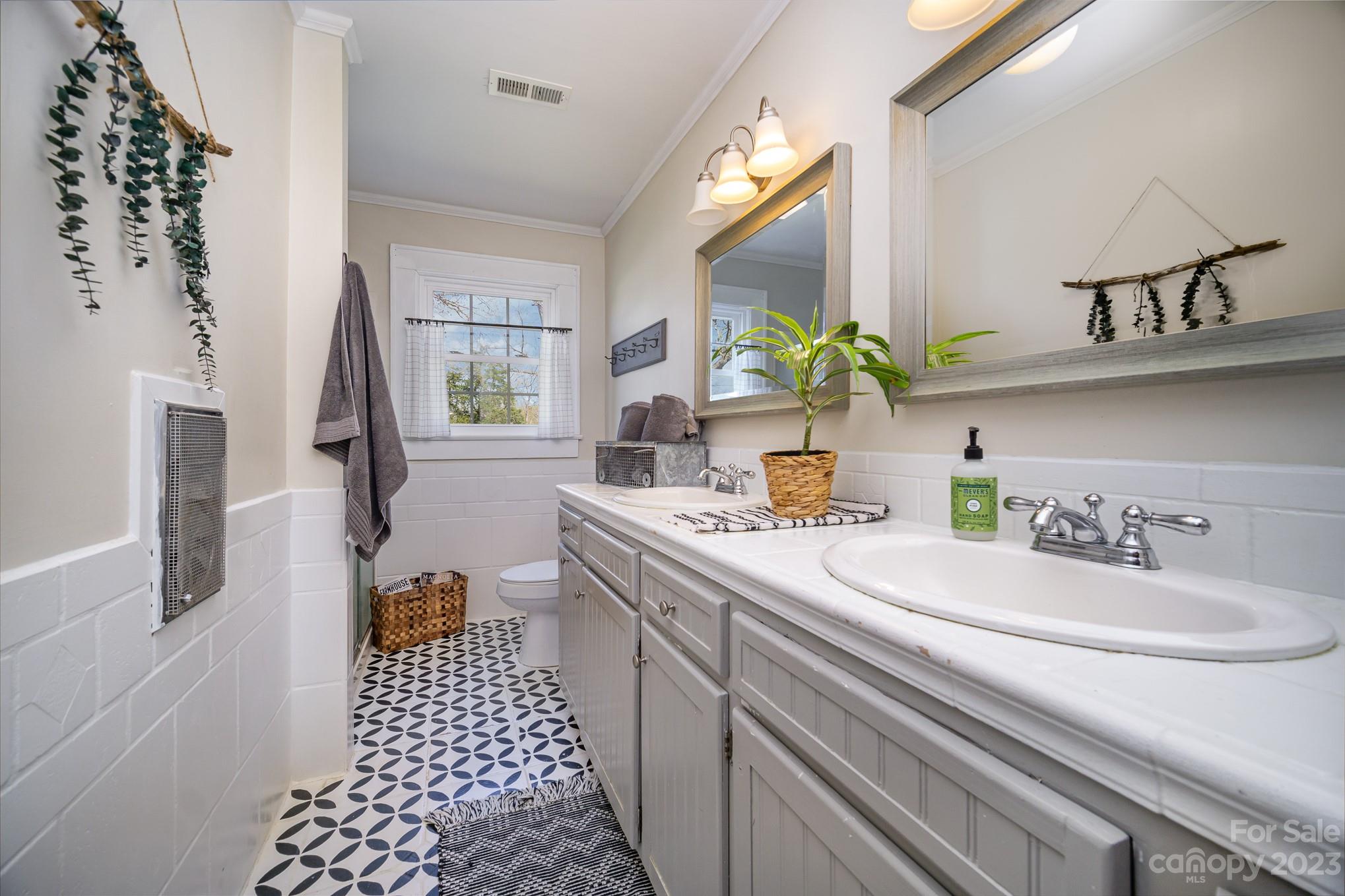 898 Hilltop Road Oakboro, NC 28129 - Photo 29 of 34 a bathroom with a sink a toilet and a mirror