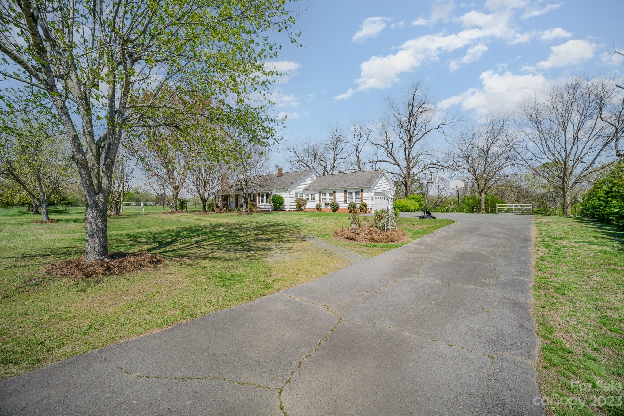 898 Hilltop Road Oakboro, NC 28129 - Photo 3 of 34 a view of a house with yard and trees