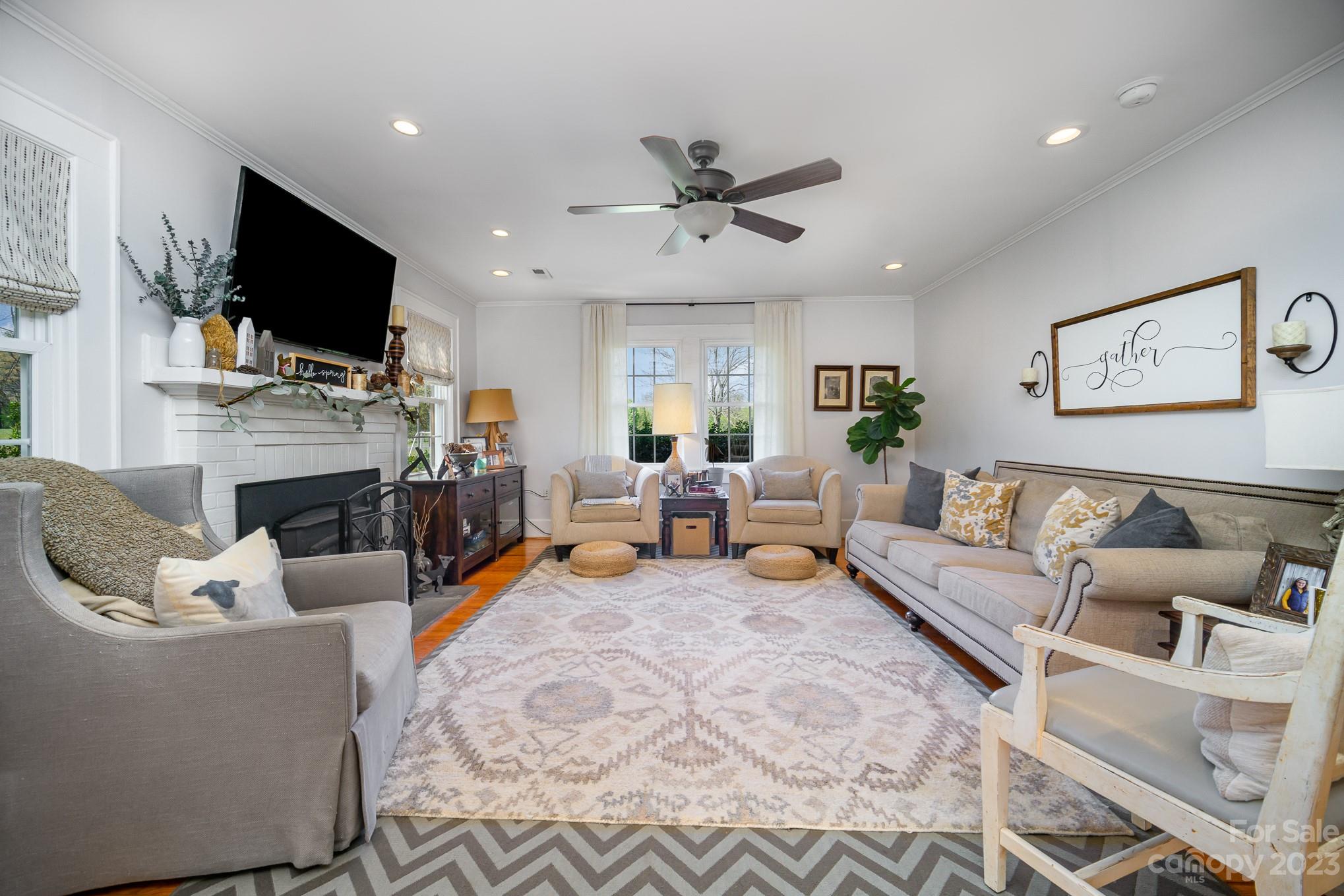 898 Hilltop Road Oakboro, NC 28129 - Photo 32 of 34 a living room with fireplace furniture and a flat screen tv