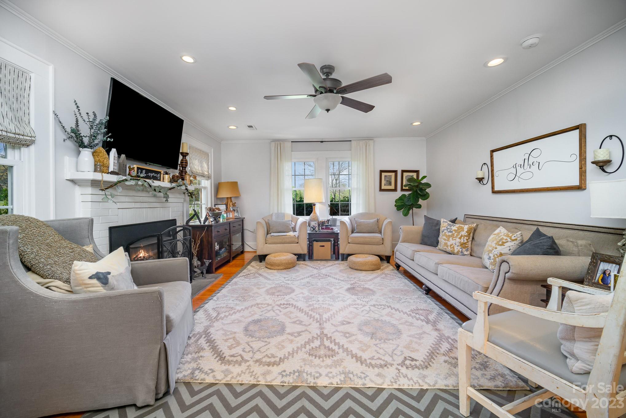 898 Hilltop Road Oakboro, NC 28129 - Photo 33 of 34 a living room with fireplace furniture and a flat screen tv