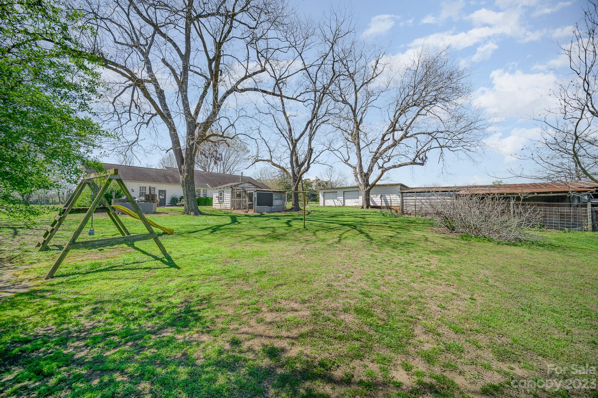 898 Hilltop Road Oakboro, NC 28129 - Photo 10 of 34 a view of a backyard with a garden