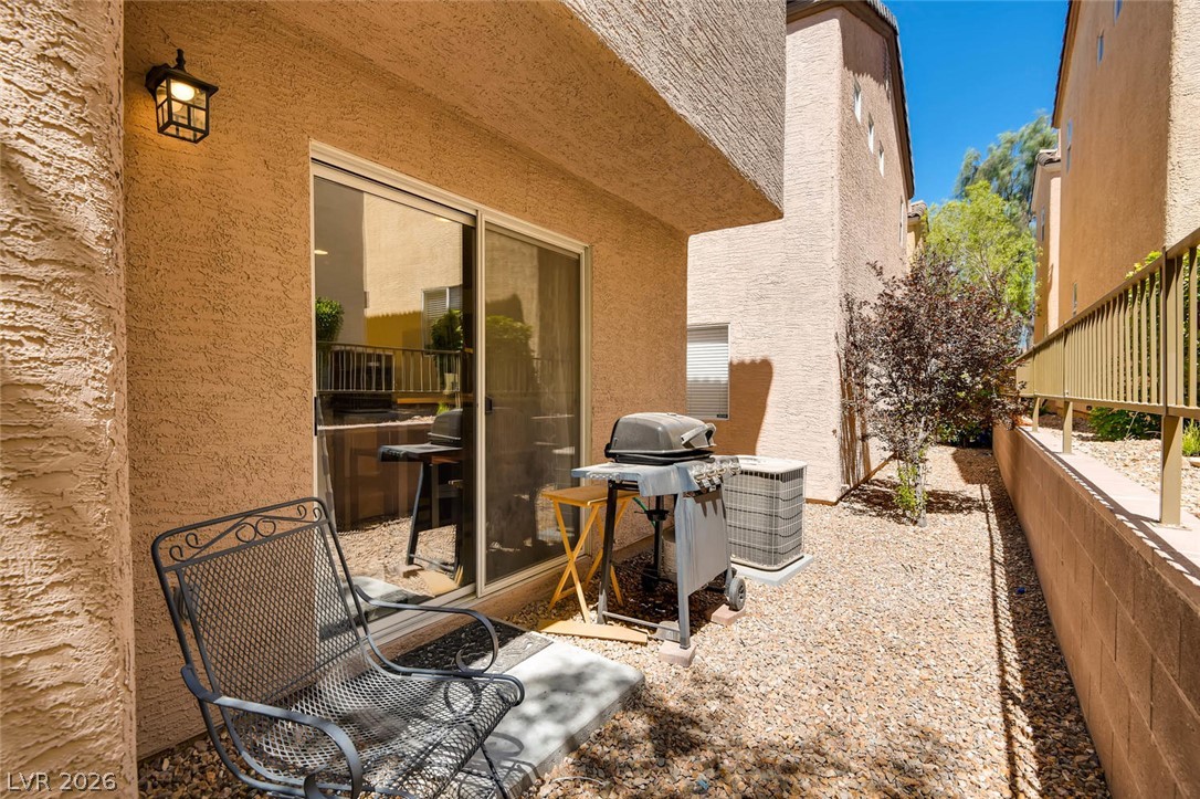 10451 Processor Court Las Vegas, NV 89129 - Photo 26 of 28 An inviting gravel patio with outdoor lighting offers a perfect spot for grilling.