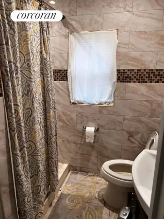 a white toilet sitting next to a shower curtain