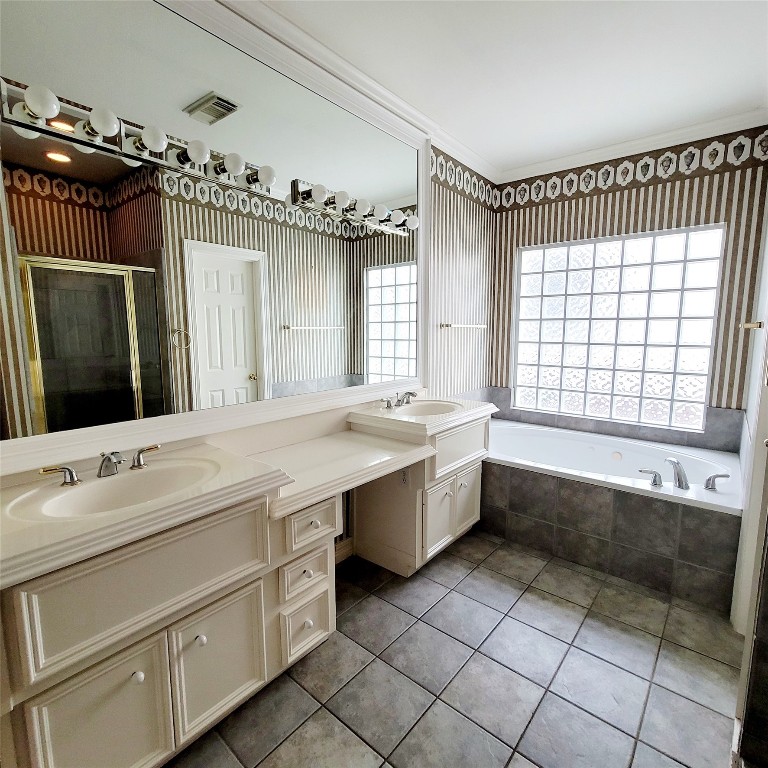1526 Nevada Street Houston, TX 77006 - Photo 23 of 38 a spacious bathroom with a double vanity sink a mirror and a bathtub