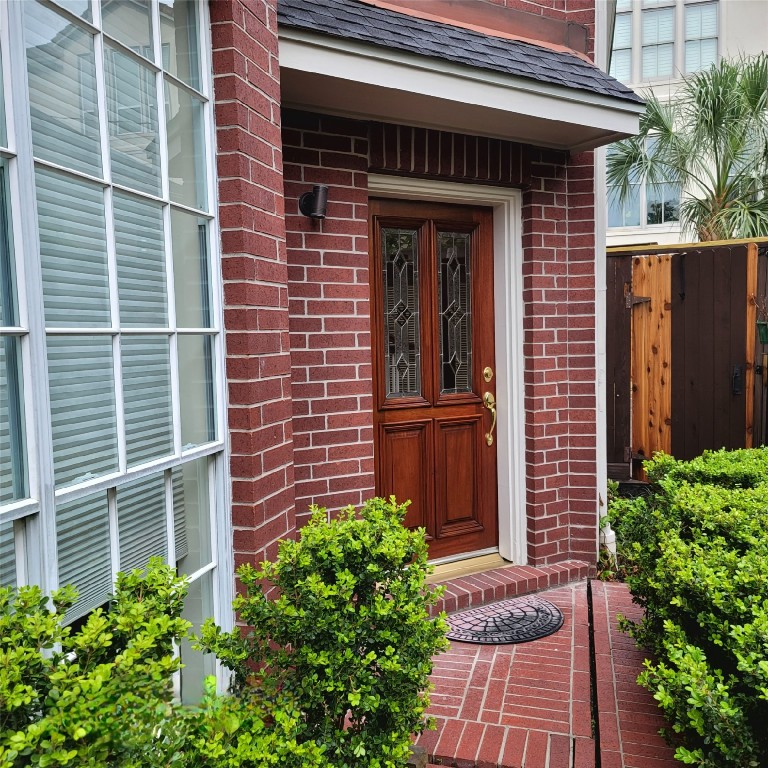 1526 Nevada Street Houston, TX 77006 - Photo 4 of 38 a view of a brick house with a large windows and flower plants