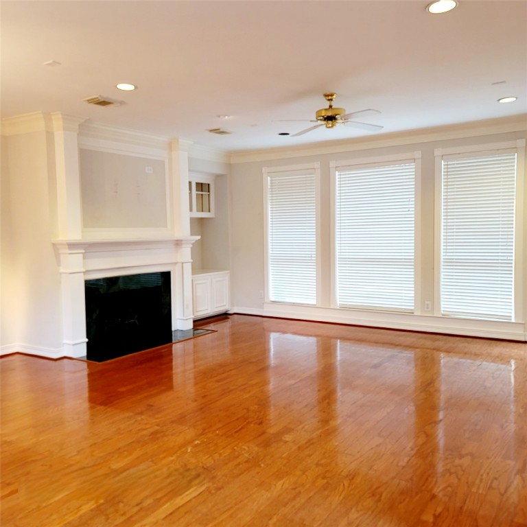1526 Nevada Street Houston, TX 77006 - Photo 6 of 38 a view of empty room with wooden floor and fireplace