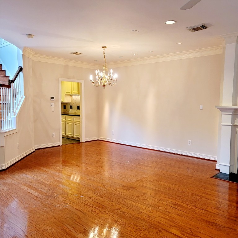 1526 Nevada Street Houston, TX 77006 - Photo 9 of 38 a view of empty room with wooden floor and kitchen