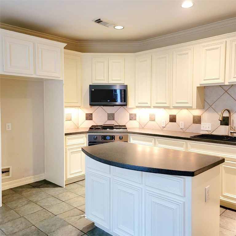 1526 Nevada Street Houston, TX 77006 - Photo 10 of 38 a kitchen with kitchen island granite countertop a sink a stove and refrigerator
