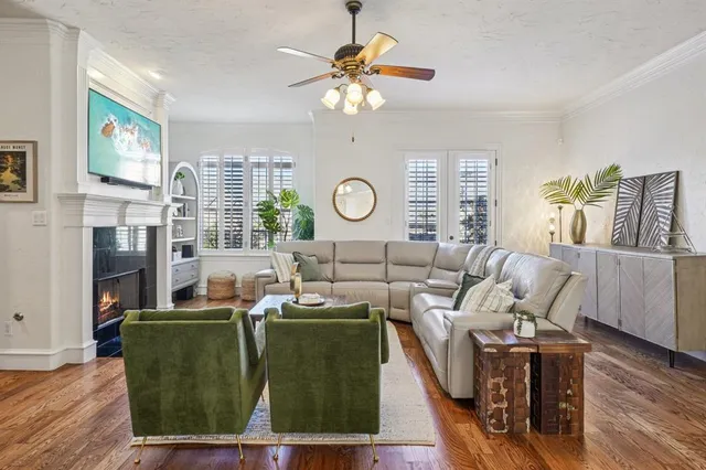 a living room with fireplace furniture and a large window