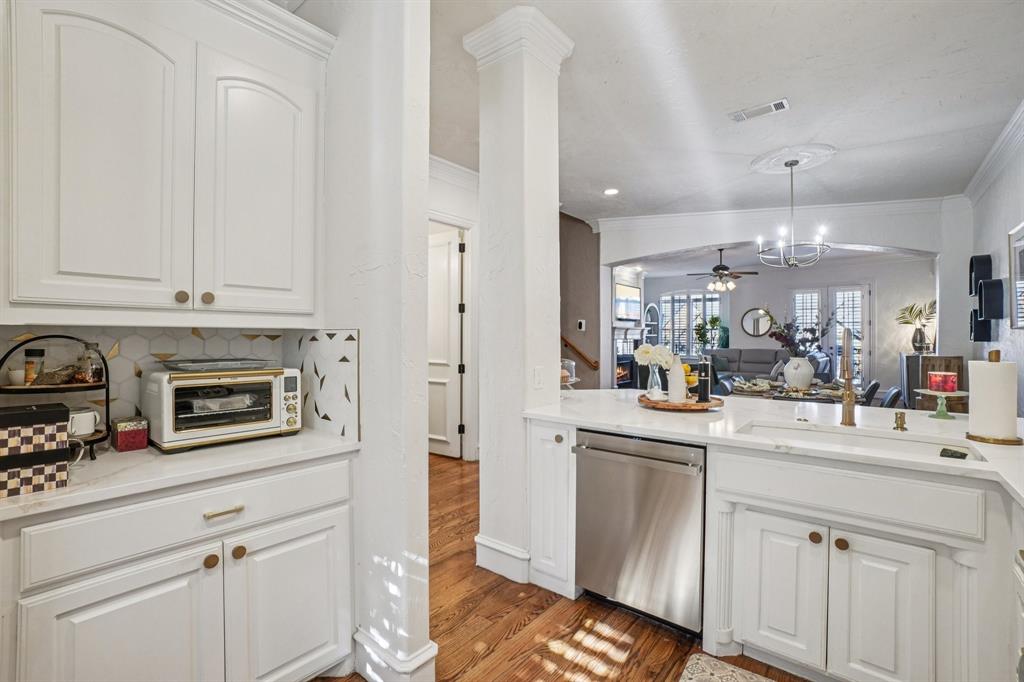 612 Rockingham Drive Irving, TX 75063 - Photo 19 of 39 a kitchen with white cabinets and sink