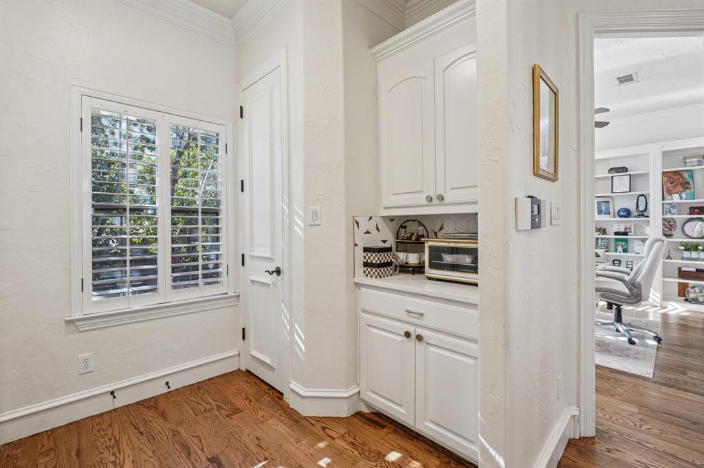 612 Rockingham Drive Irving, TX 75063 - Photo 21 of 39 a kitchen with white cabinets and wooden floor