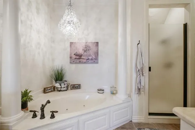 a bathroom with a tub sink and mirror