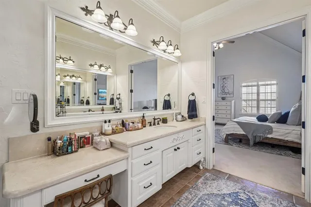 a spacious en suite bathroom with double vanity and mirrors