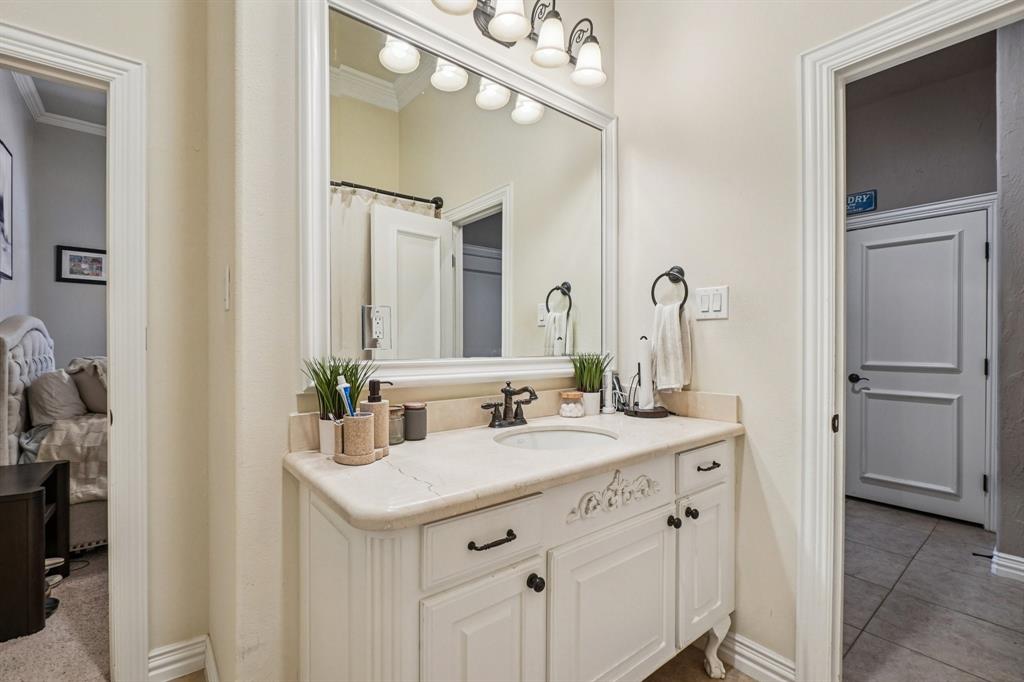 612 Rockingham Drive Irving, TX 75063 - Photo 35 of 39 a bathroom with a sink vanity and a mirror