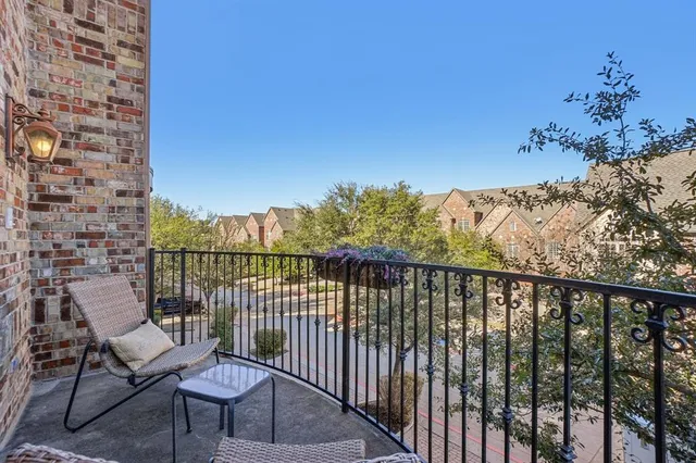 a view of a balcony with wooden floor and outdoor seating